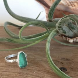 A bright turquoise sea glass ring.