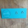 Pair of small triangle stud earrings pointing 'up' on turquoise Porth earring card.
