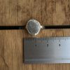 Grey sea-pebble ring - Swanpool next to ruler. Stone measures approximately 15mm wide.