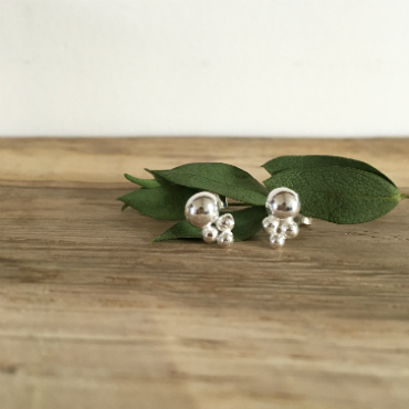 Silver studs Featuring one large silver pebble with three small ones below in a triangle.