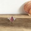 Pink seaglass ring. The seaglass is cut into a kite shape. Front view.